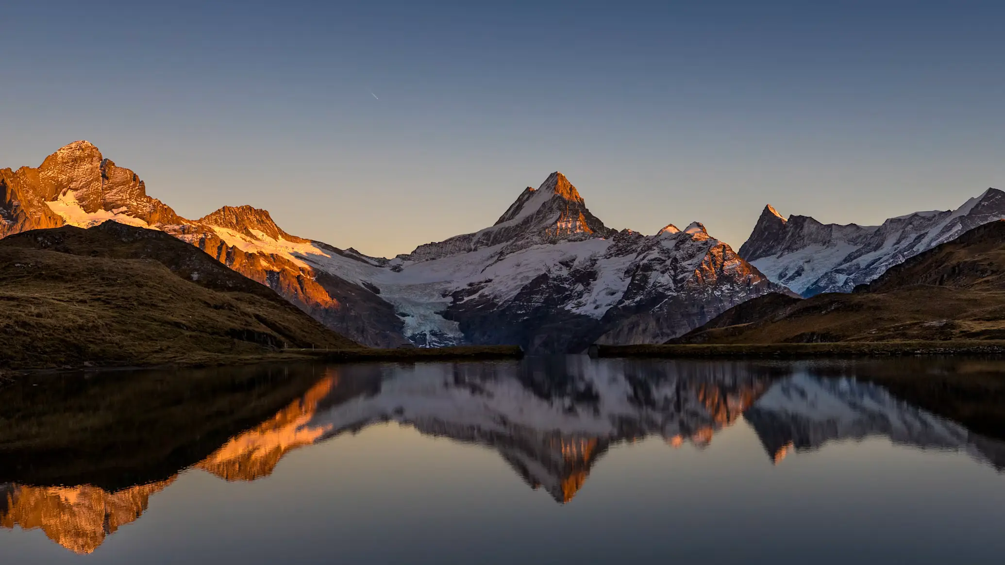 Bachalpsee mirror reflection of Schreckhorn and Wetterhorn massif at sunrise above Grindelwald, Bernese Oberland Switzerland