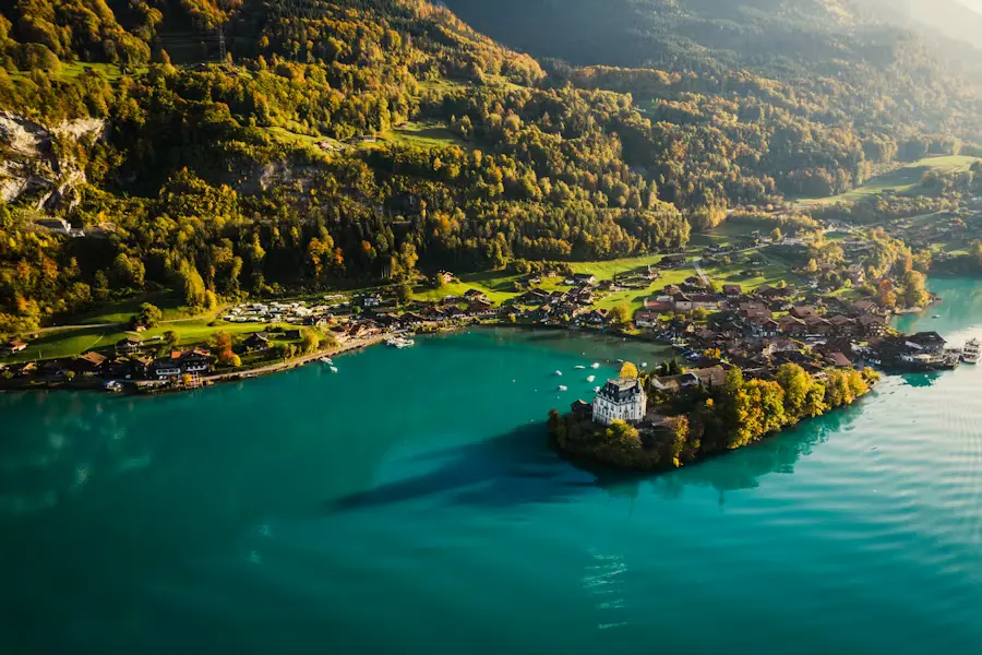 Iseltwald village and lakeside manor on turquoise Lake Brienz in autumn, Bernese Oberland Switzerland