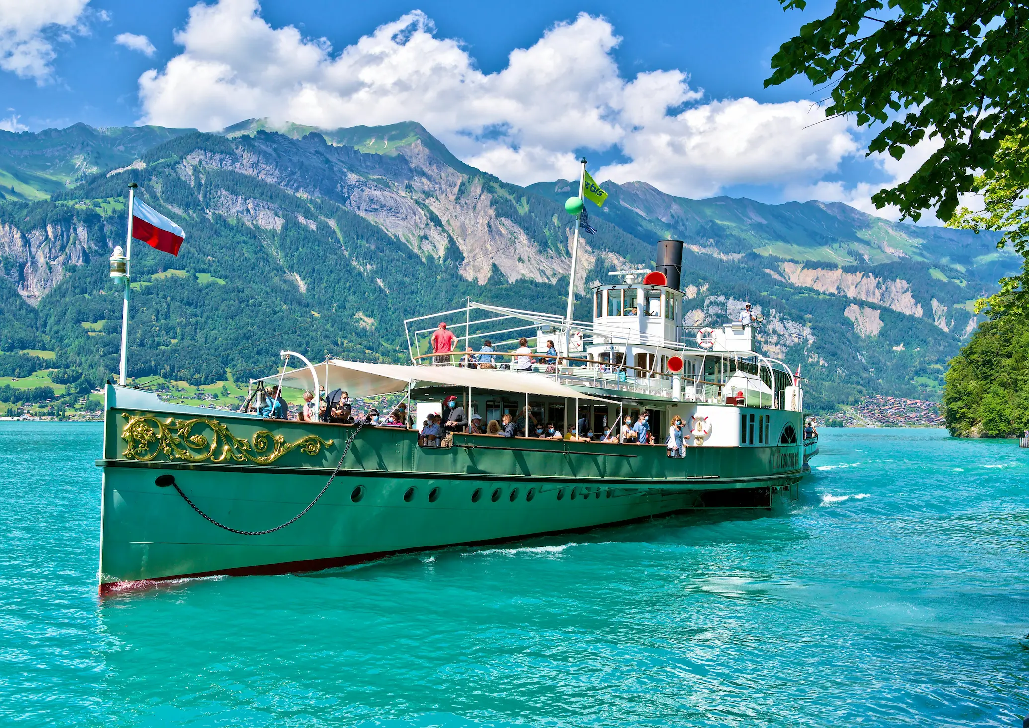 BLS paddle steamer Lötschberg crossing turquoise Lake Brienz with Swiss Alps in the background, Interlaken Switzerland