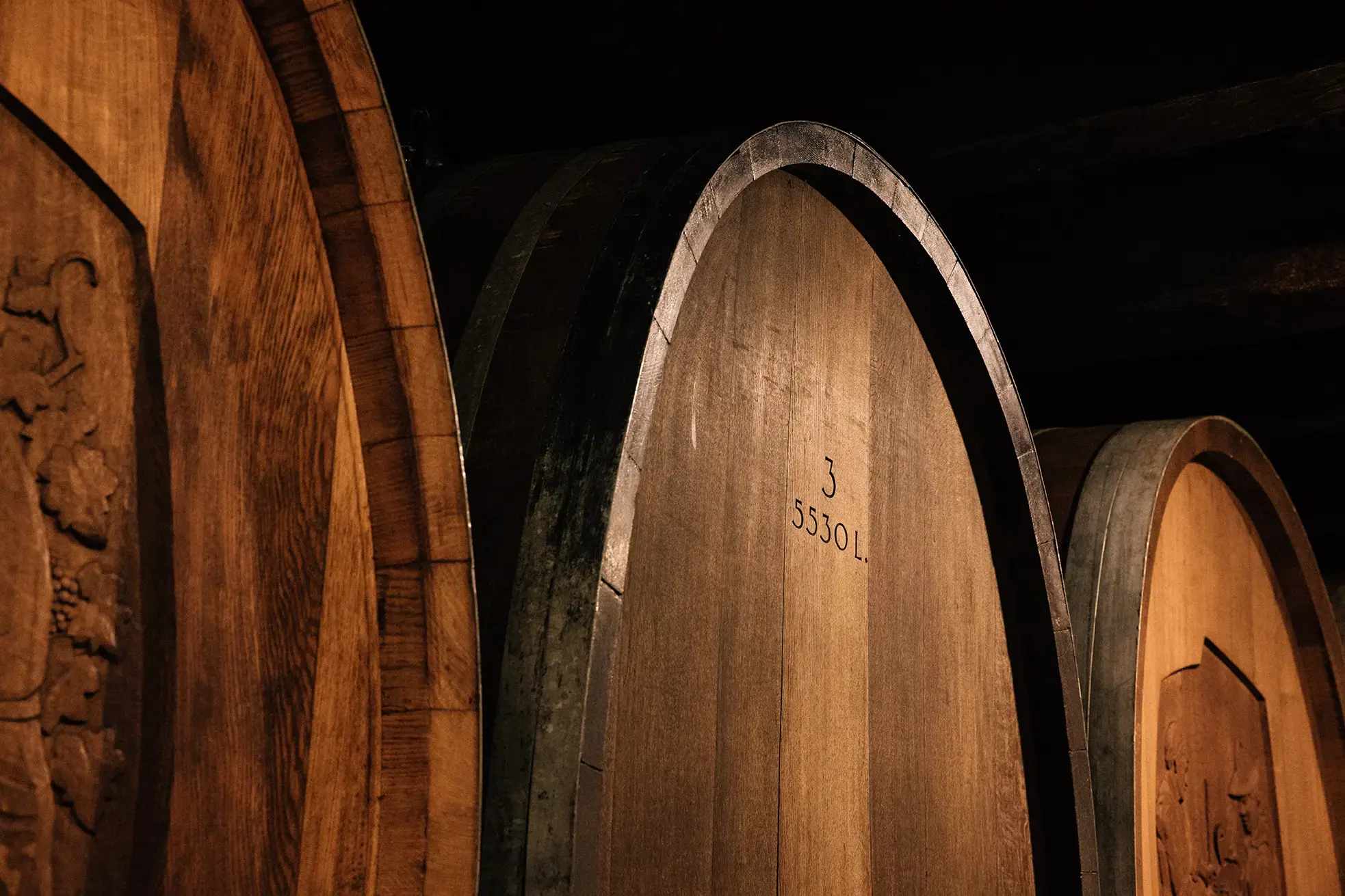 5530-litre carved oak barrels in Rebbau Spiez wine cellar, traditional ageing casks for Spiezer Blauburgunder Pinot Noir
