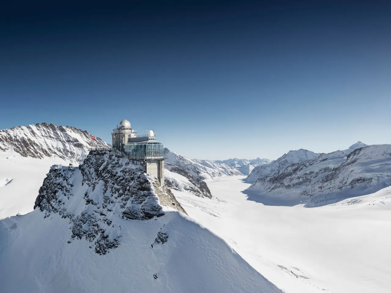Jungfraujoch Top of Europe observatory at 3454 metres with Aletsch glacier stretching below on a clear day Switzerland