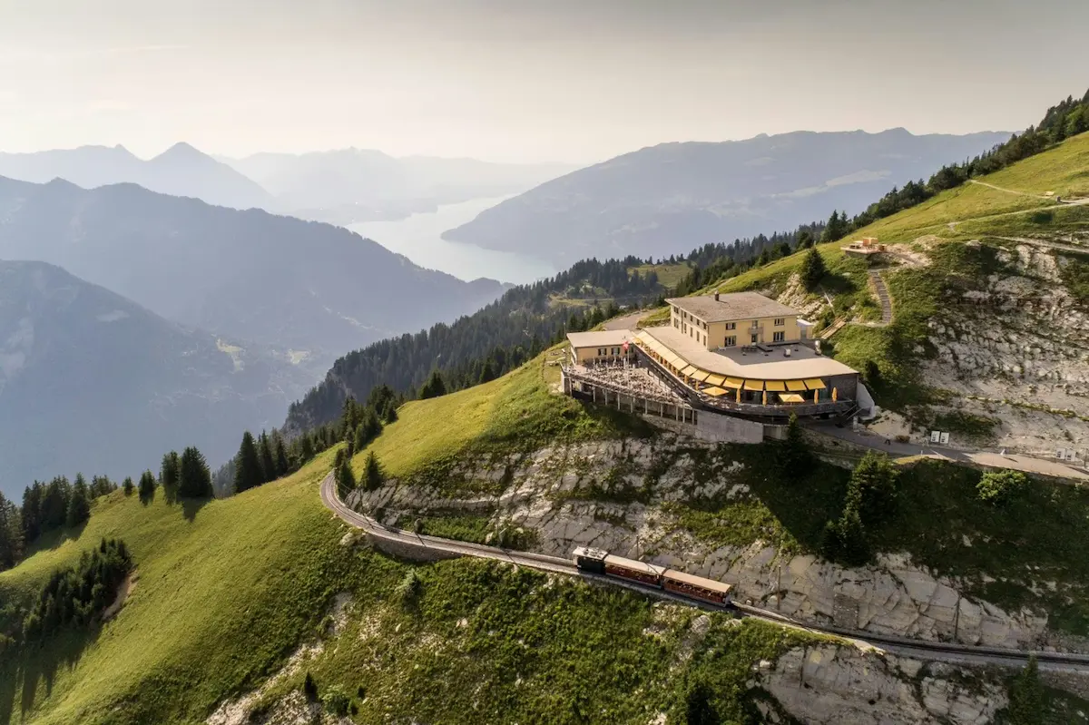 Schynige Platte cogwheel railway and mountain restaurant above Interlaken with Lake Thun panorama Switzerland