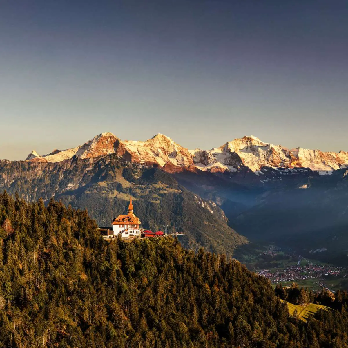 Harder Kulm viewpoint above Interlaken at golden hour with Eiger Mönch and Jungfrau peaks Switzerland